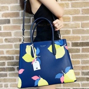 Navy and Lemon Kate Spade with carry handles and shoulder strap.
